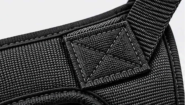 Detailed shot of durable hardware and heavy-duty structural stitching on a LuxryPaw dog harness designed for strong pullers and secure control.