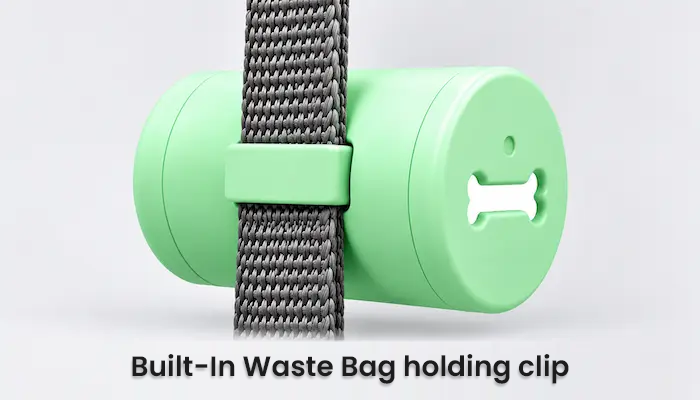 A mint green cylindrical dog poop bag holder with a gray woven strap and a bone-shaped clip, shown on a light gray background with the text 'Built-In Waste Bag holding clip' at the bottom.