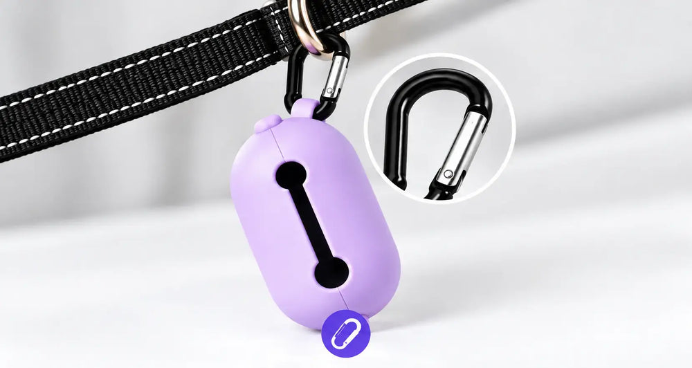 A lavender purple pet ID tag attached to a black collar, with a circular inset showing a close-up of the black carabiner clip.