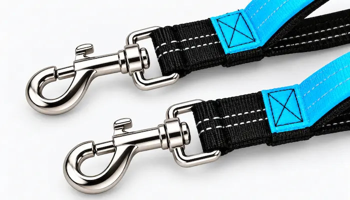 Two black and bright blue dog leashes with silver metal swivel snap hooks, displayed on a clean white background.