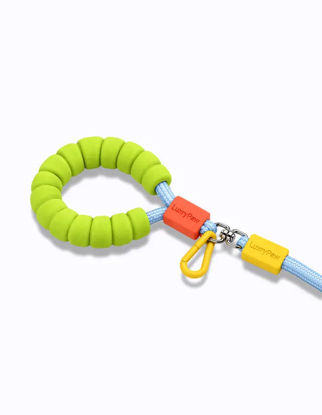 blue LuxryPaw braided rope dog leash featuring a bright green cushioned foam handle and a light blue nylon lead.