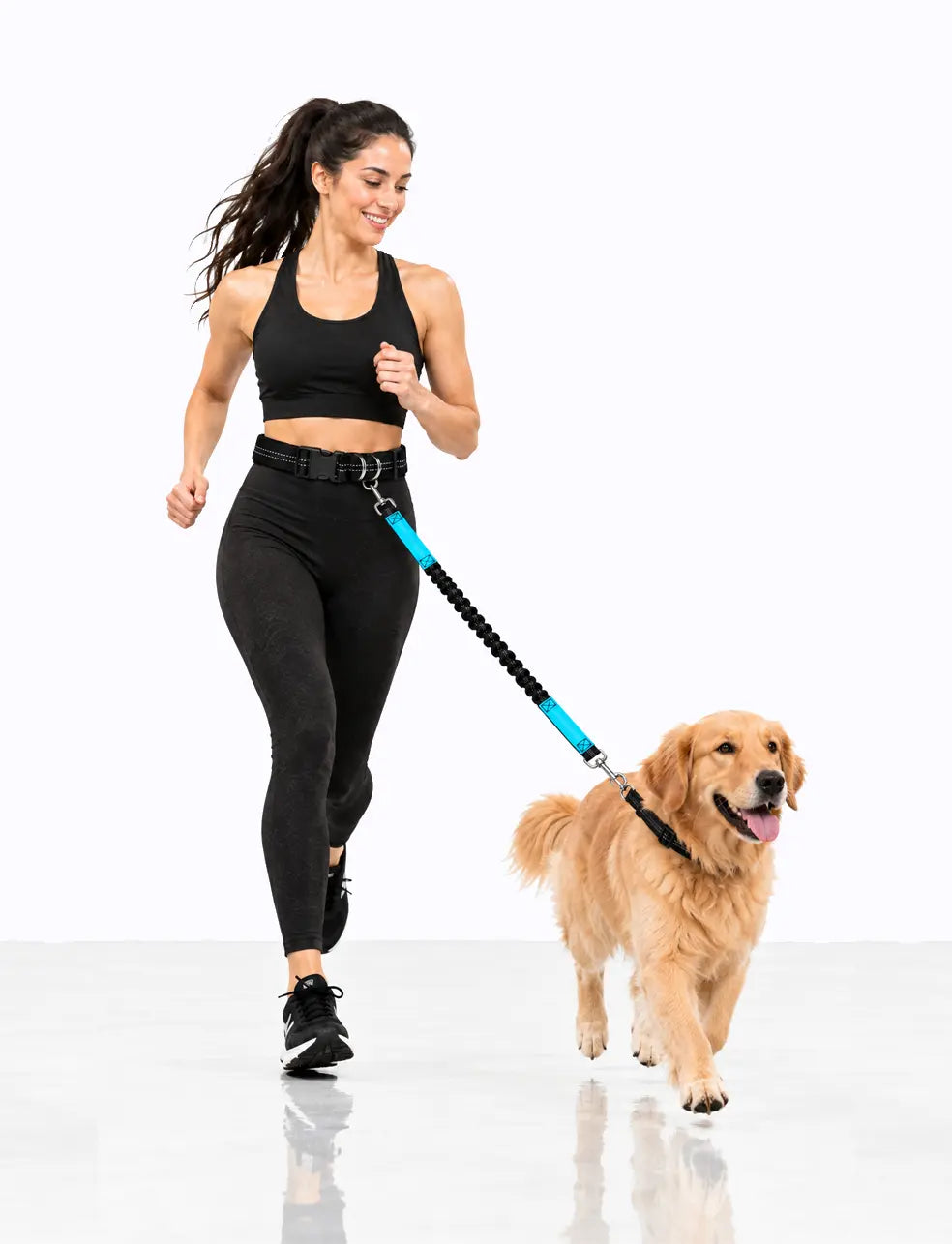 blue Woman jogging with a Golden Retriever using a LuxryPaw hands-free bungee dog leash with dual handles and waist belt.