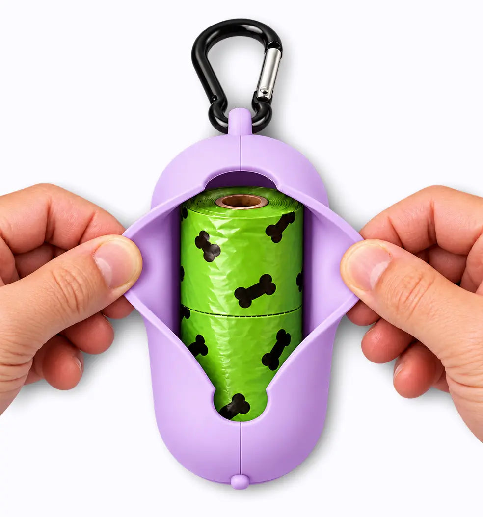 lilac LuxryPaw silicone pet waste bag holder being opened to reveal a green bone-print poop bag roll with carabiner